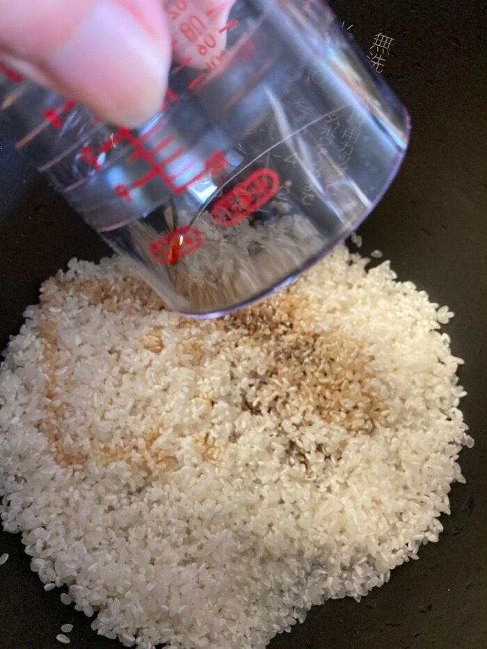 研いだお米に麺つゆを入れる