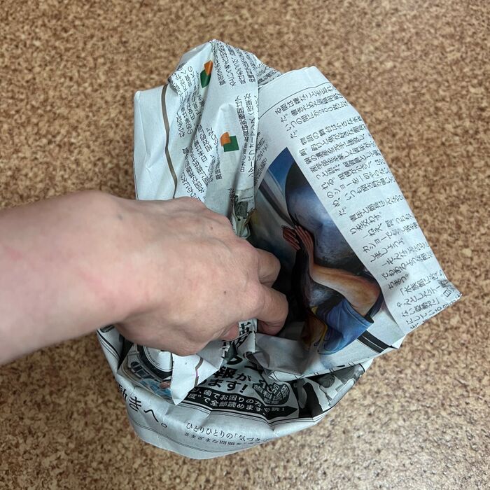 缶の中に新聞紙を詰めます。