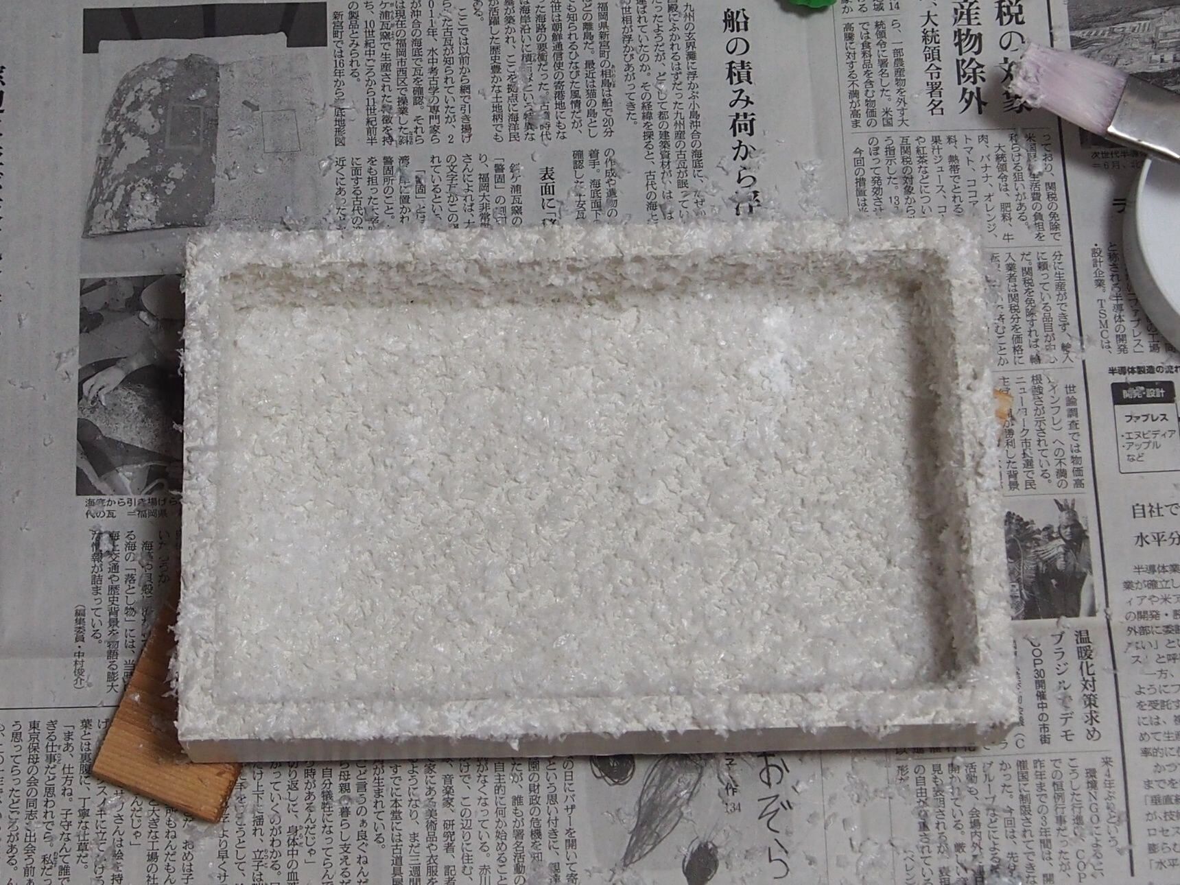 ①まずは、箱に白色のペンキを塗り、アーティフィシャルスノー（スノーパウダー）を降らせます