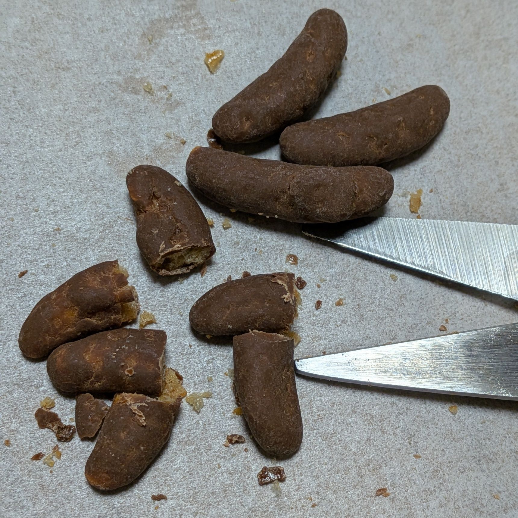 2、柿の種チョコをハサミで半分に切る。