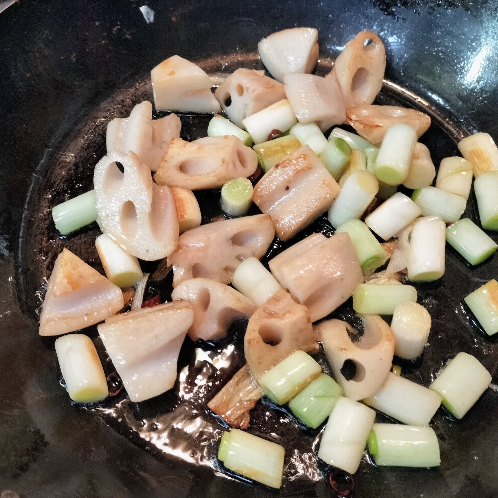 2. れんこんと長ネギ（白い部分）を中火でじっくりと焼き、焼き色をつける