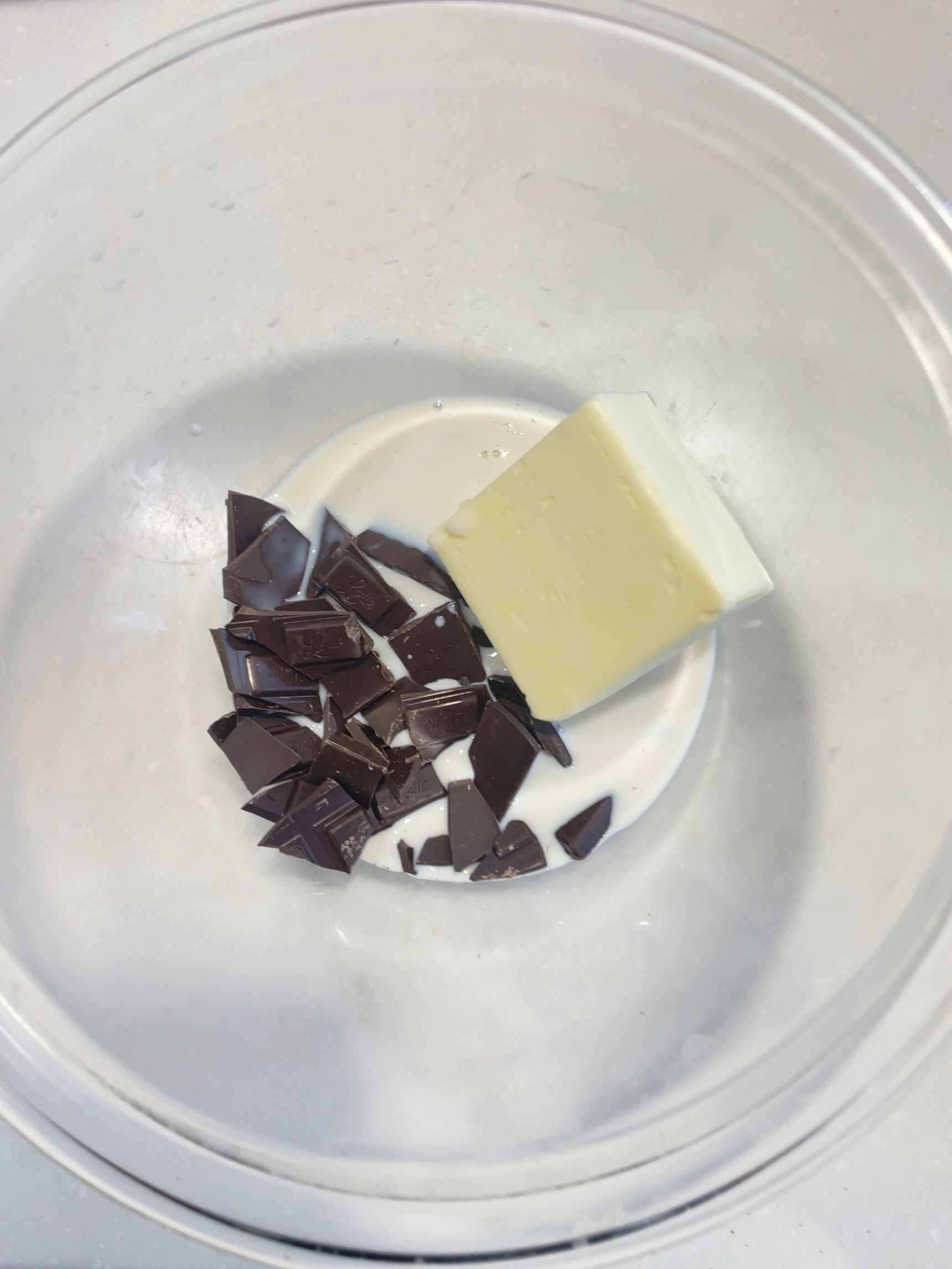 耐熱ボウルに無塩バター、刻んだ板チョコ、牛乳を入れて加熱