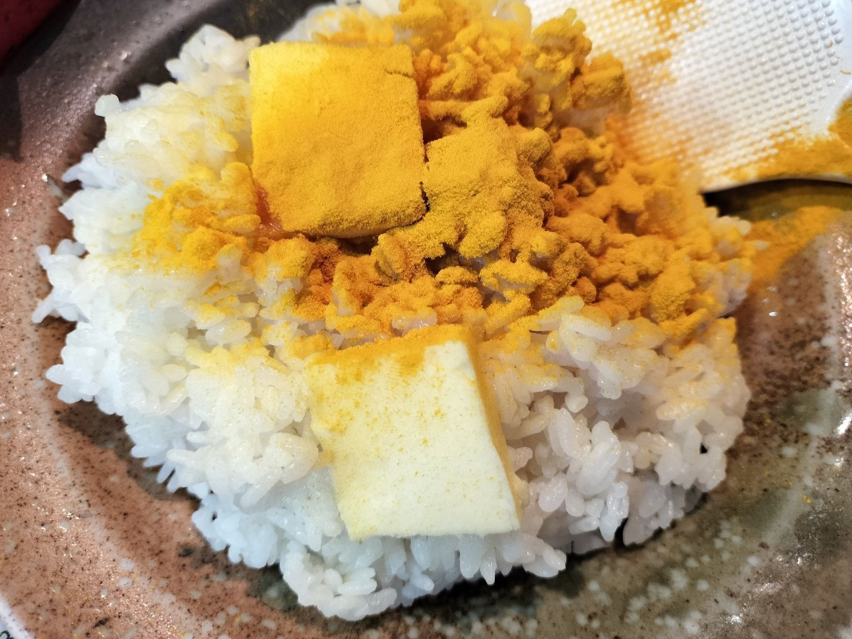 4、耐熱皿に、温かい白飯を入れる→バターをのせ、ターメリックをふりかけて混ぜる→電子レンジで1分程加熱して混ぜる　※加熱時間は調整して下さい