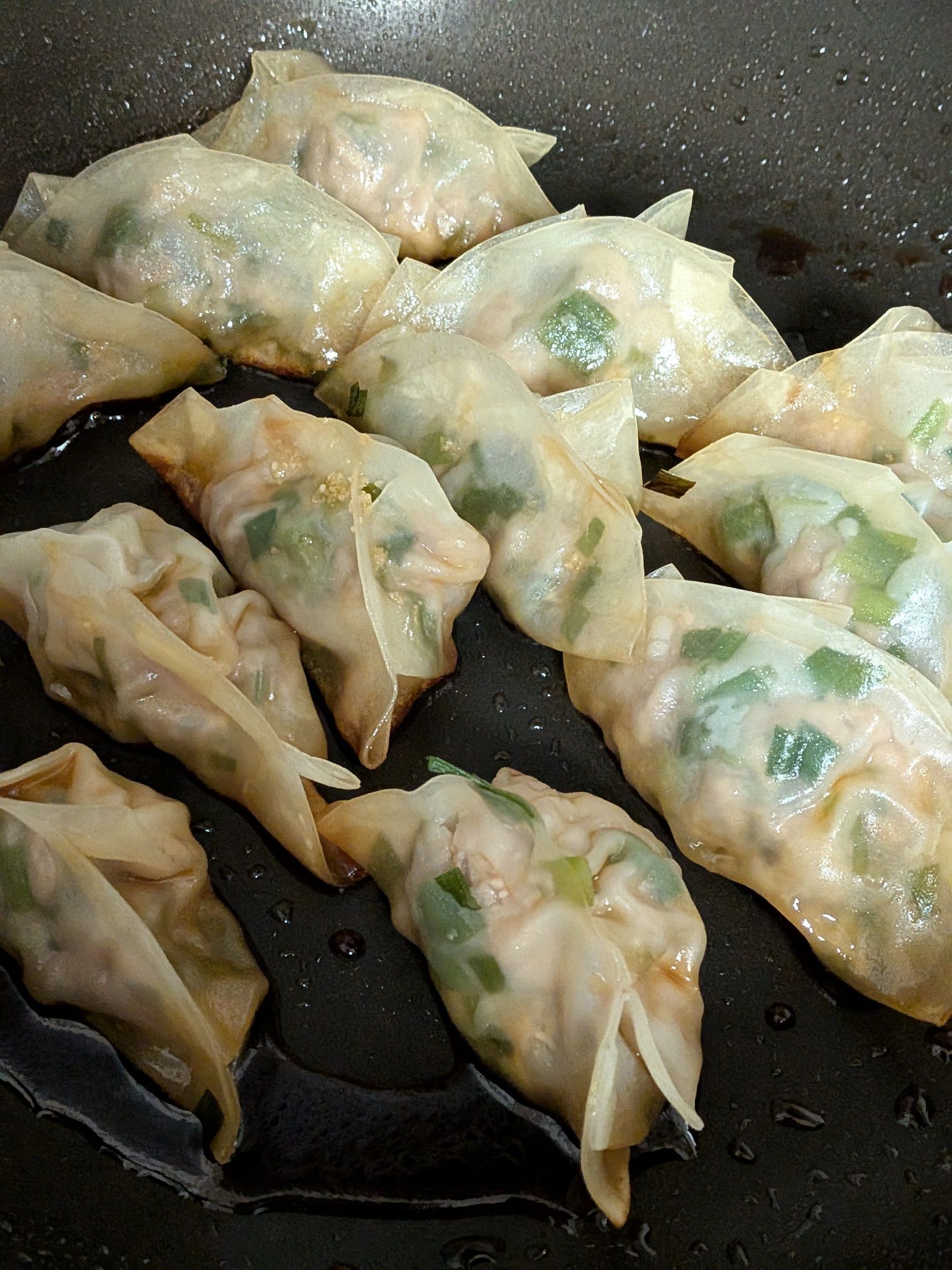 5、残りの餃子も焼く。この時、焼き上がったら●の半量を流し入れ、餃子に絡める。