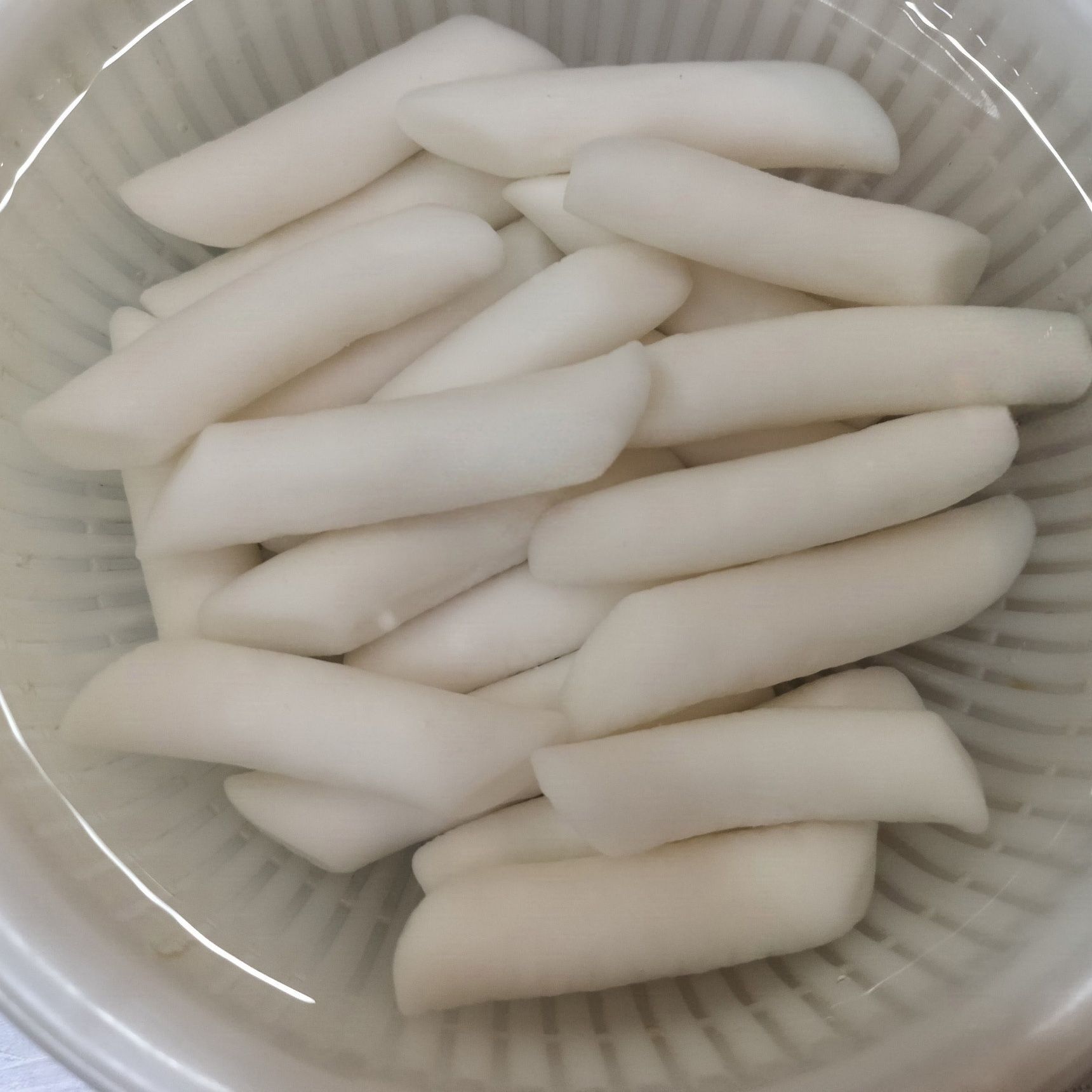 1、ボウルにザルをセットして、トッポギ餅を入れる。適量の水を注ぎ入れ、30分程浸しておく。